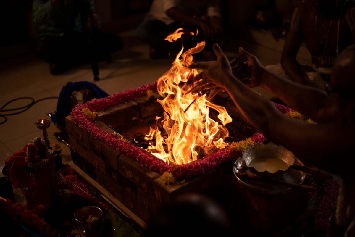 Authentic Vedic havan ceremony with sacred fire, flowers and offerings